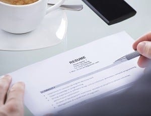 Close-up Of Photo Business Person Holding Resume